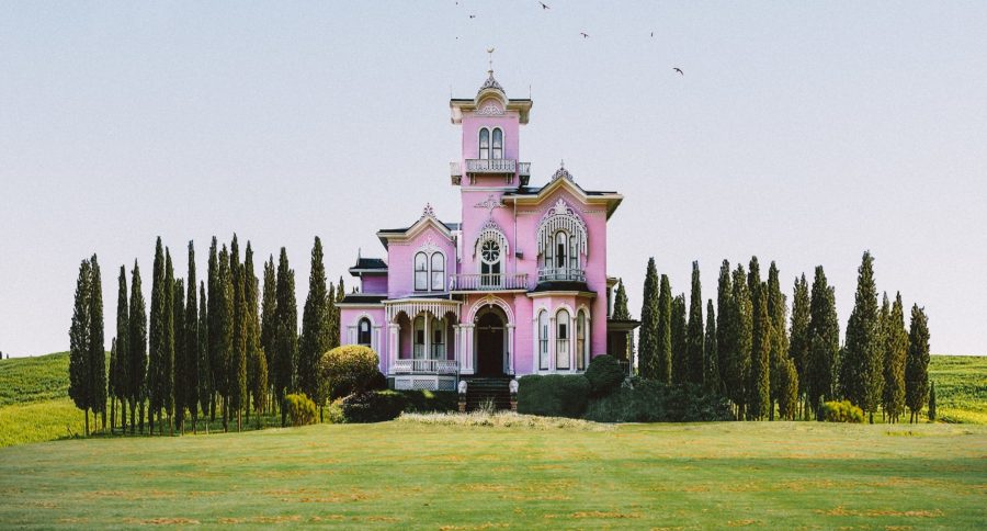 Large pink building set in an open green space