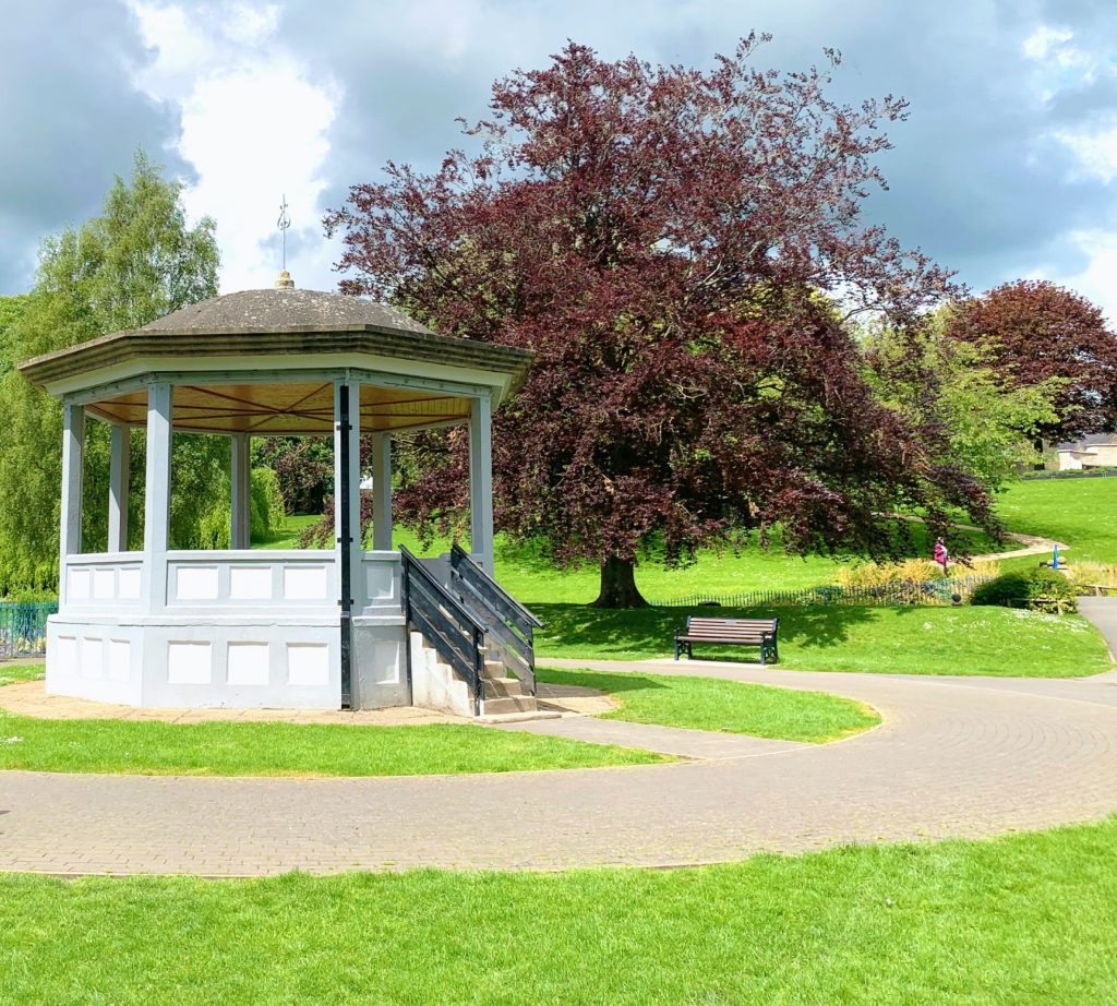 Public park / space with grass and bandstand