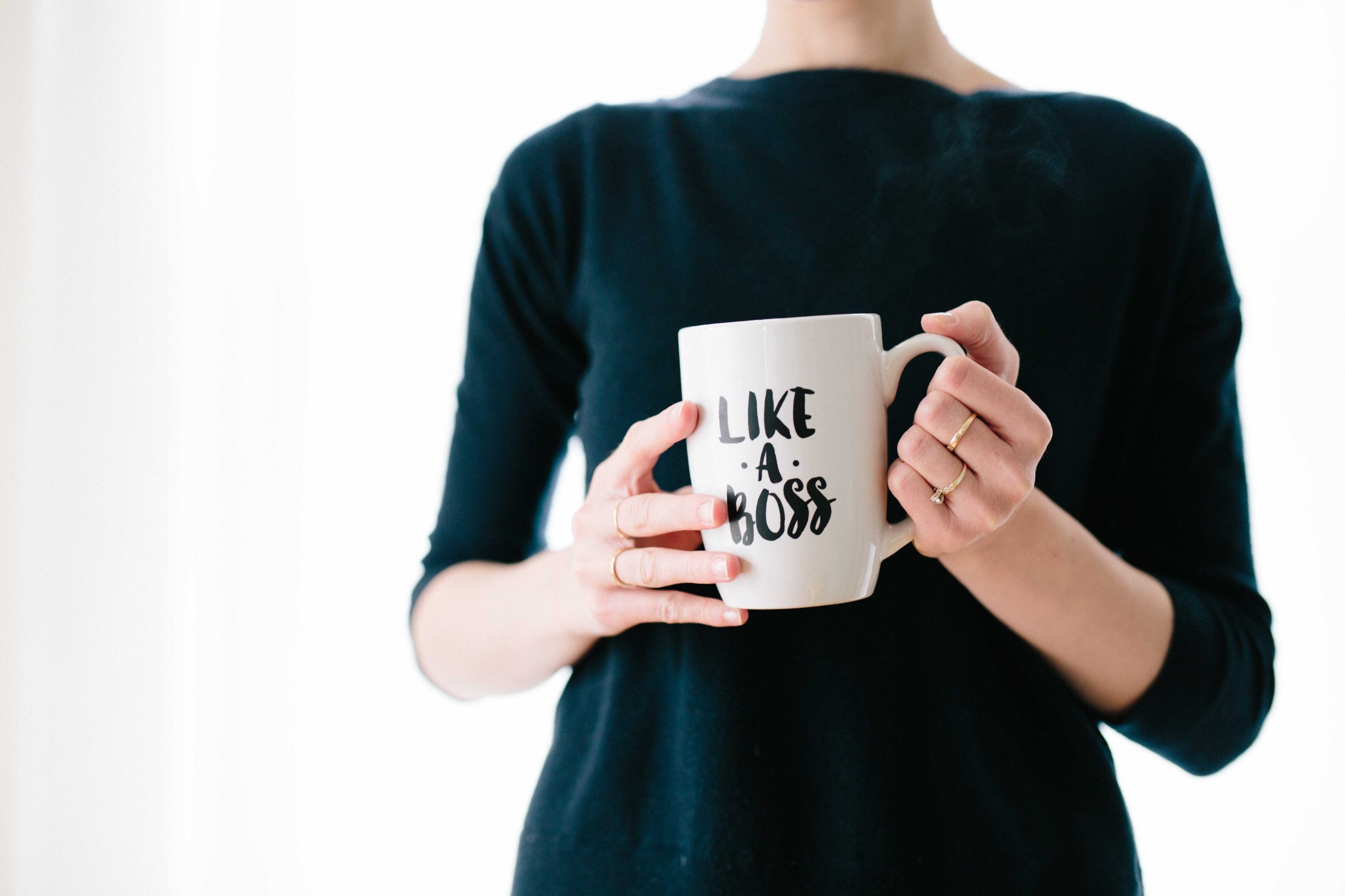 Person holding a 'Like a Boss' mug