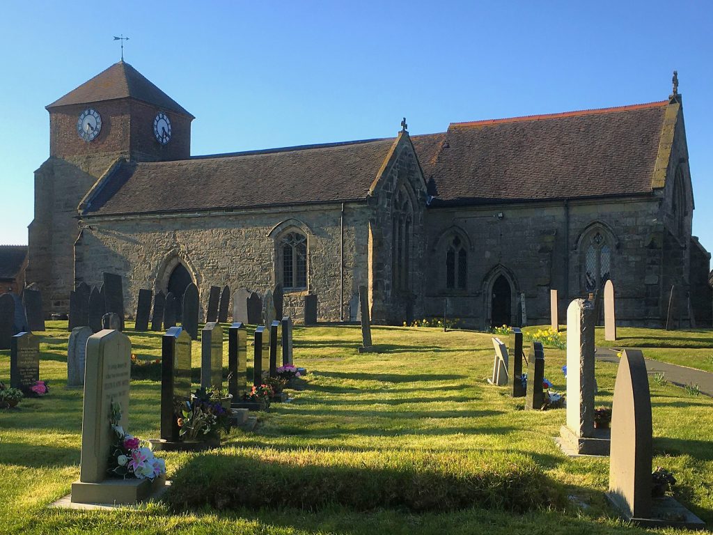 Photo of a church and cemetery
