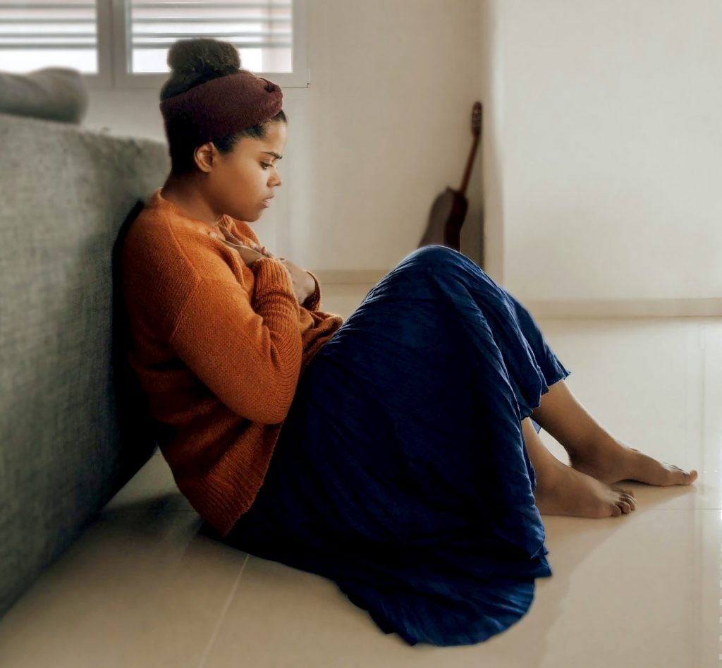 Anxious woman sat on floor