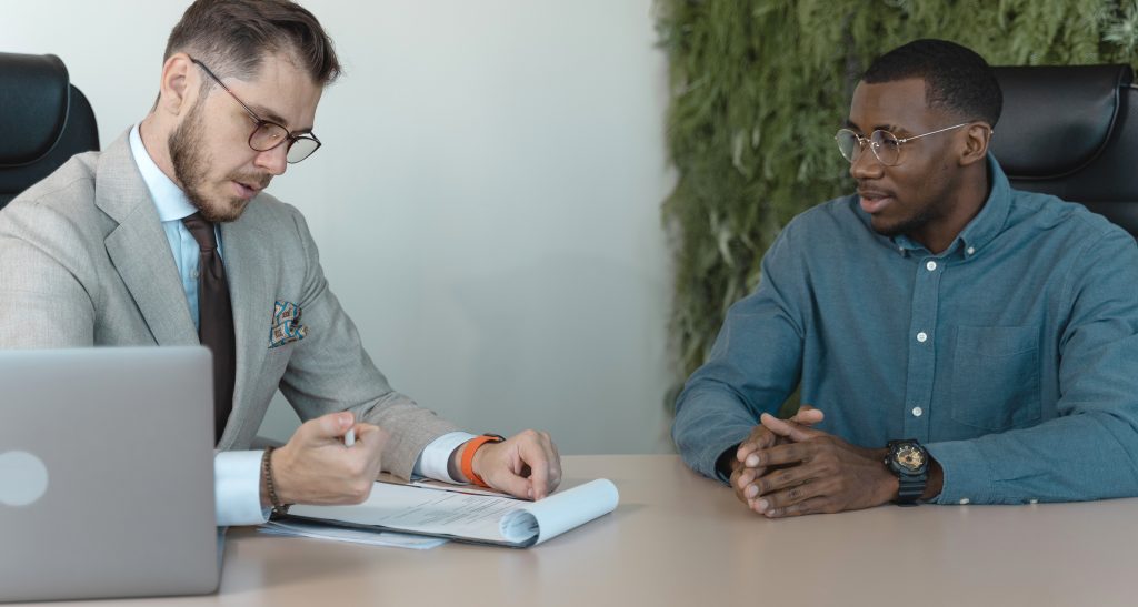 Feedback meeting between two male colleagues